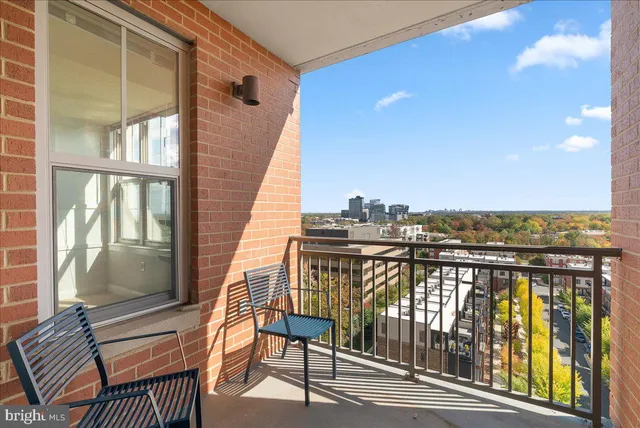 a view of a balcony with wooden floor and outdoor seating
