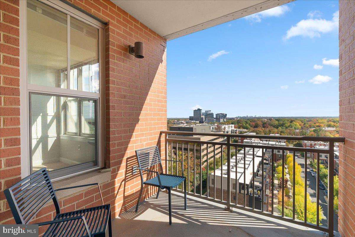 11760 Sunrise Valley Drive, Unit 909 Reston, VA 20191 - Photo 17 of 20 a view of a balcony with wooden floor and outdoor seating