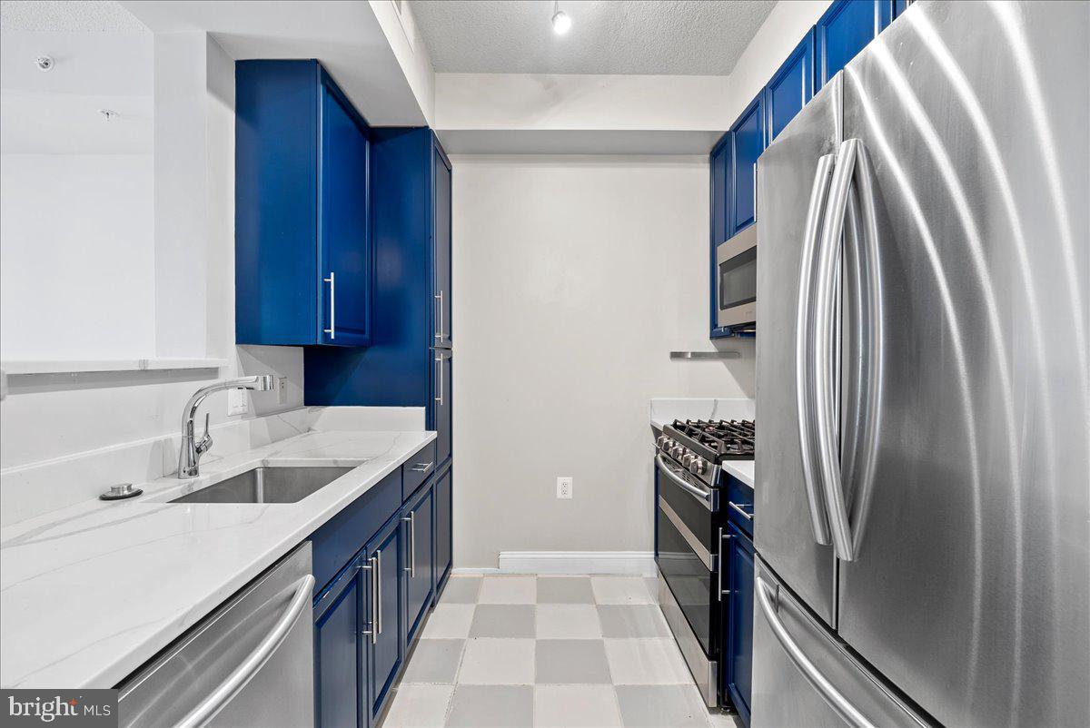 11760 Sunrise Valley Drive, Unit 909 Reston, VA 20191 - Photo 2 of 20 a kitchen with a sink and a refrigerator