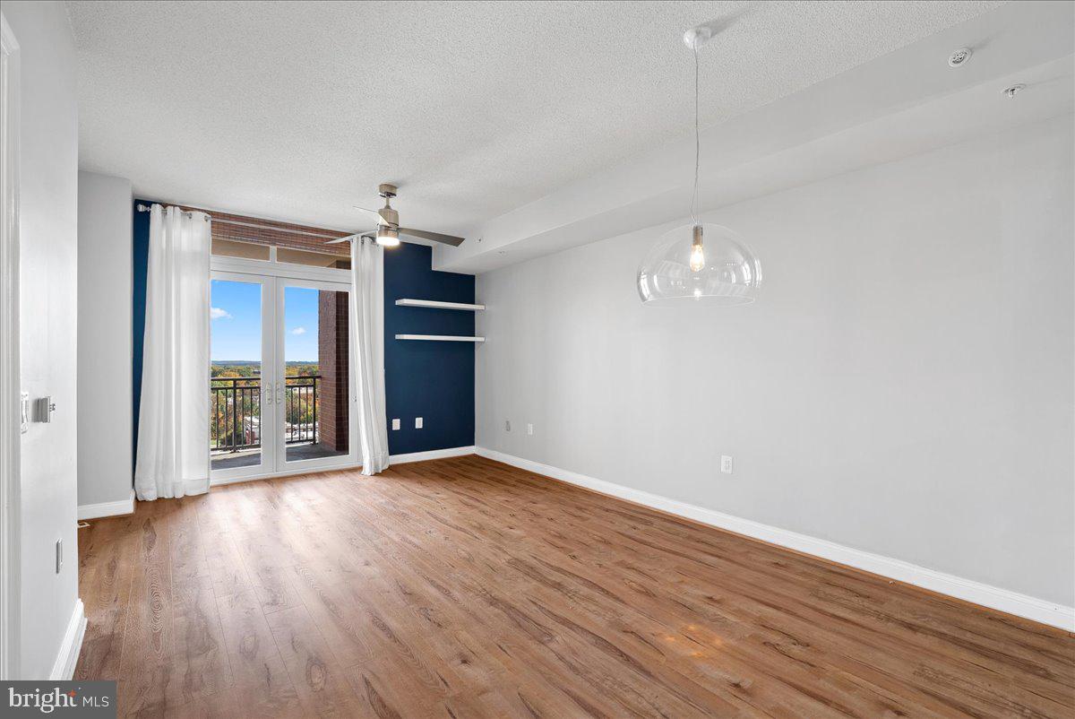 11760 Sunrise Valley Drive, Unit 909 Reston, VA 20191 - Photo 6 of 20 wooden floor in an empty room with a window