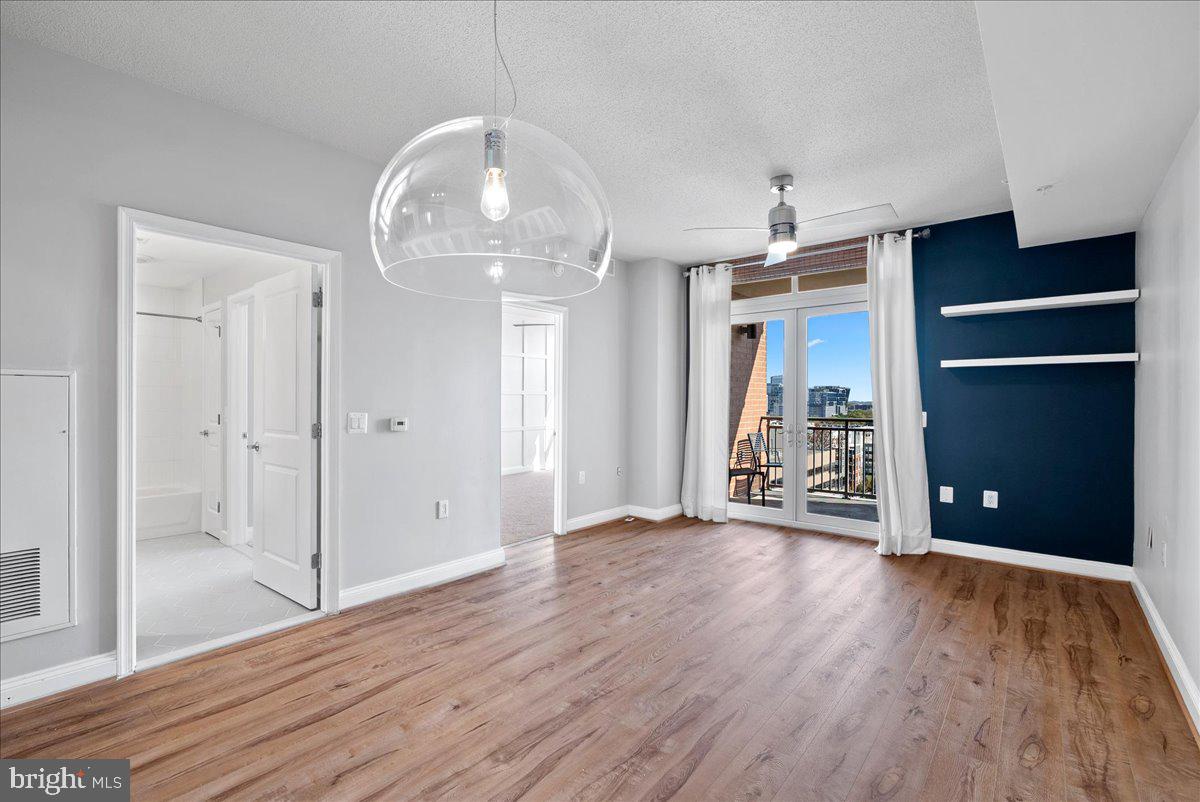 11760 Sunrise Valley Drive, Unit 909 Reston, VA 20191 - Photo 7 of 20 wooden floor in an empty room with a window