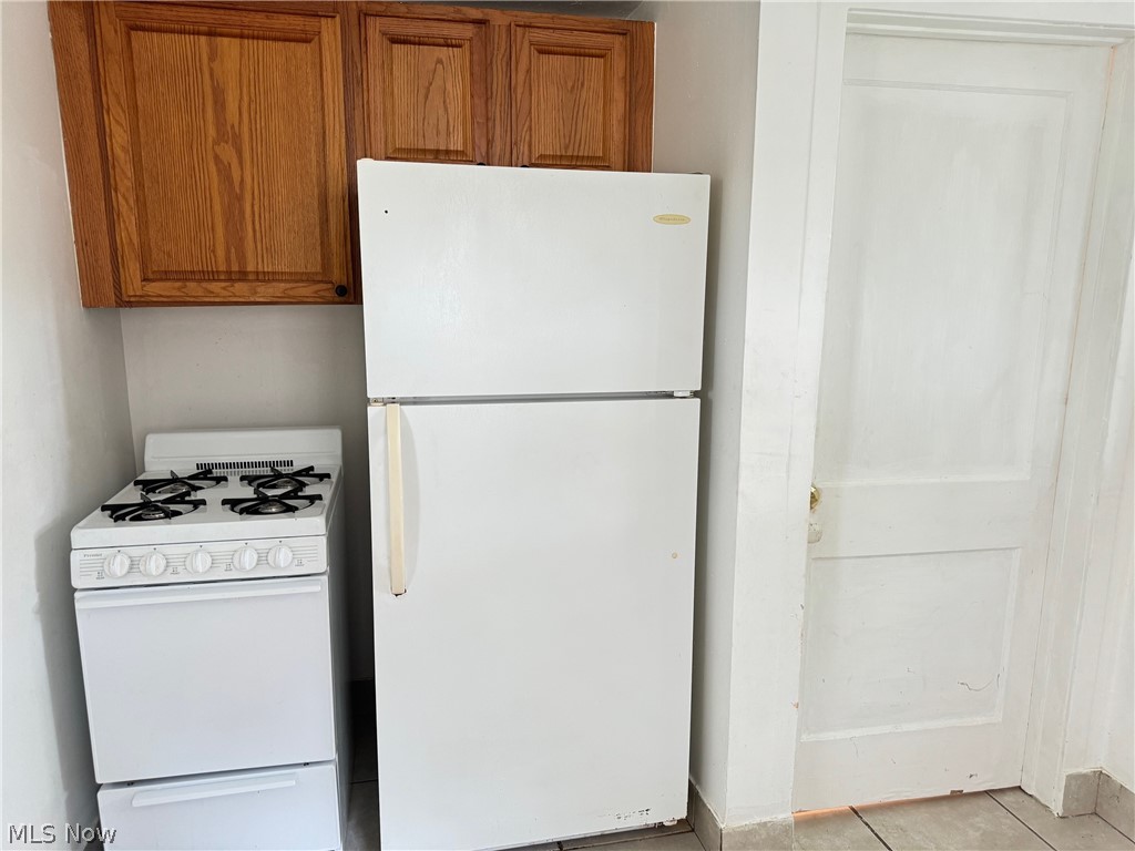 459 Patterson Avenue Akron, OH 44310 - Photo 18 of 24 1st floor apt. Kitchen featuring white appliances and light tile floors