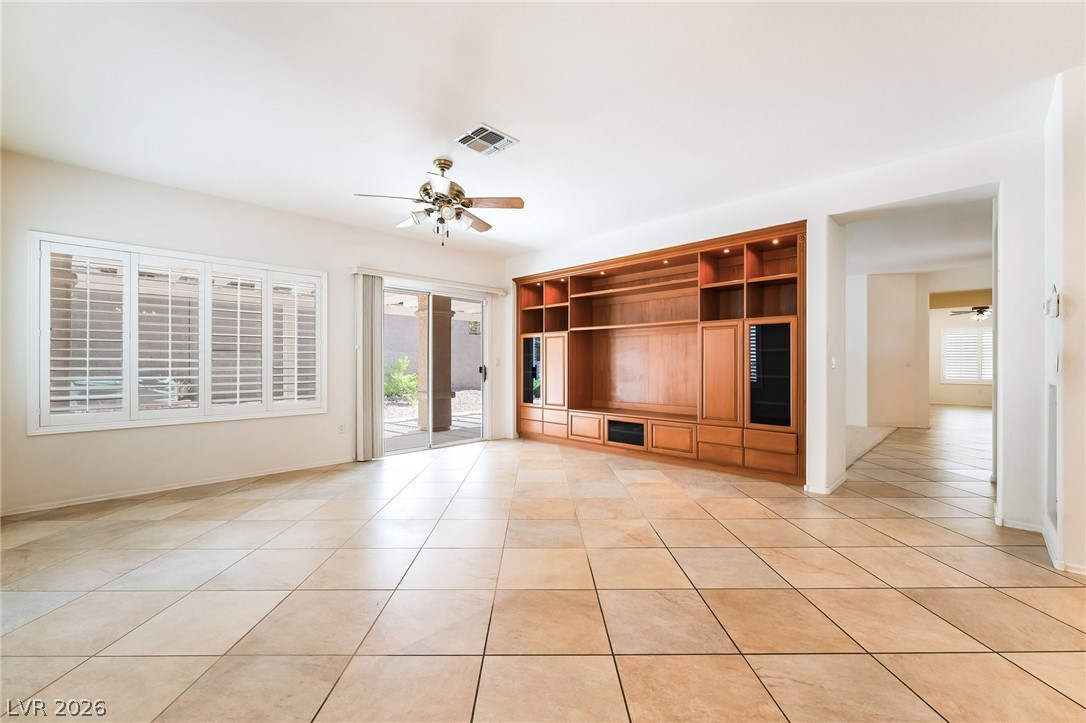3033 Hartsville Road Henderson, NV 89052 - Photo 13 of 41 A spacious living area showcasing a built-in entertainment center and abundant natural light.
