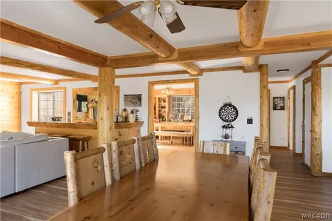 a view of a kitchen and dining room with wooden floor