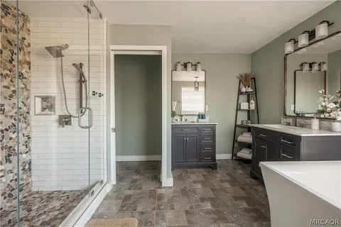 a spacious bathroom with a sink and a mirror