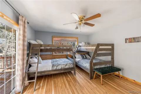 a bedroom with a bunk bed and a desk