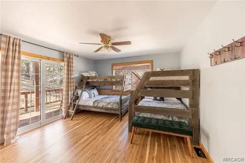 a bedroom with bed and wooden floor