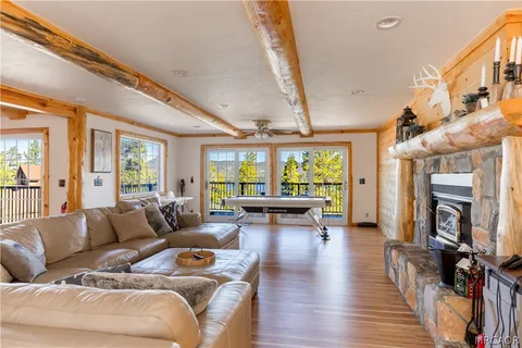a living room with furniture a fireplace and a large window