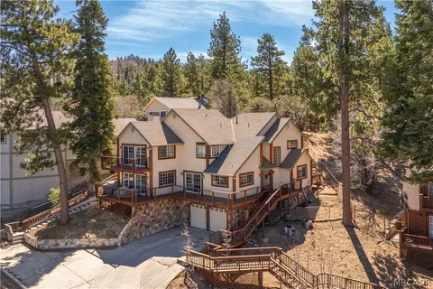 a aerial view of a house with yard porch and furniture