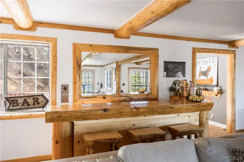 a view of a kitchen with granite countertop a sink and a dining table