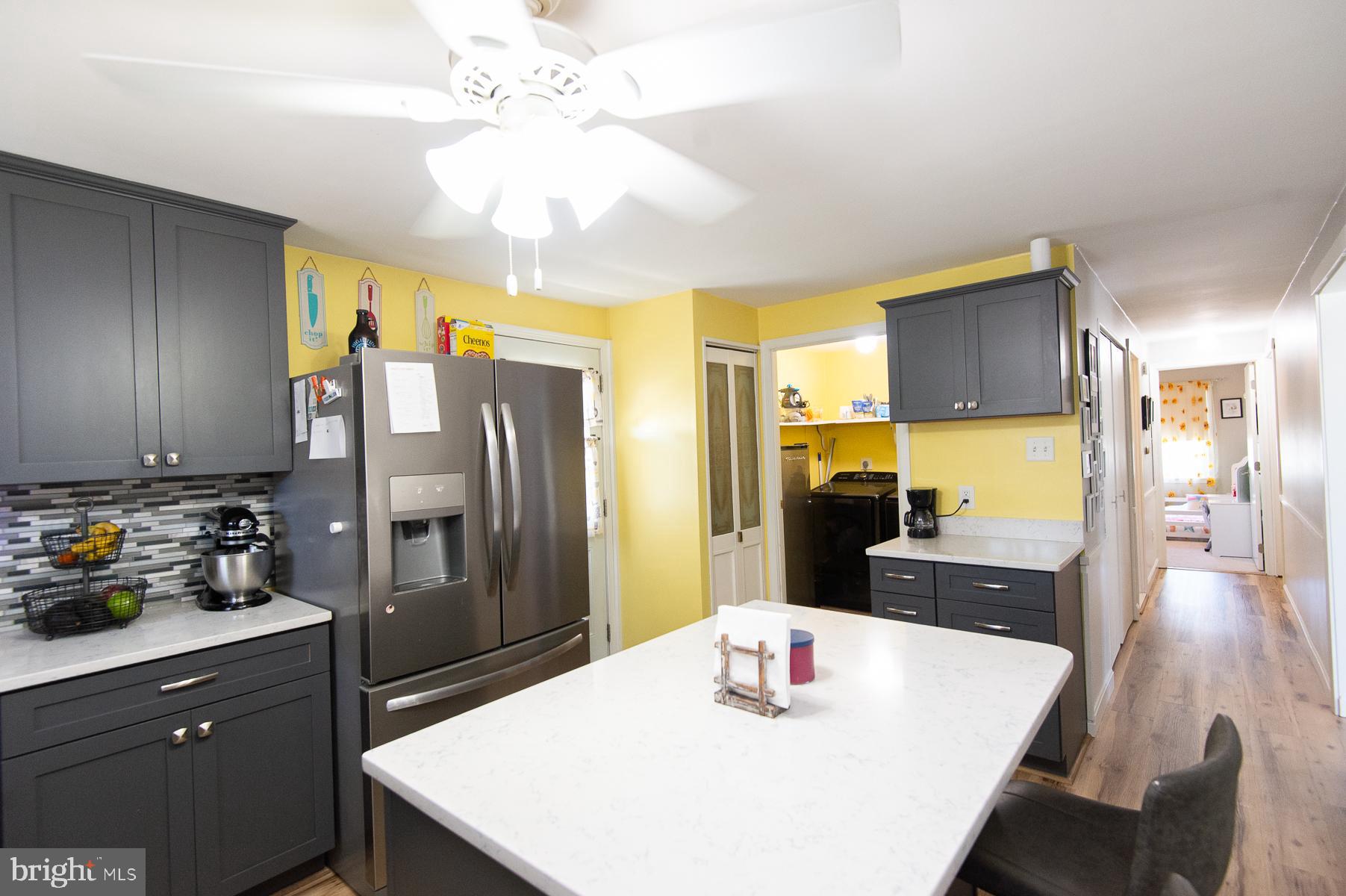 12 North Maple Avenue Ridgely, MD 21660 - Photo 28 of 30 a kitchen with stainless steel appliances granite countertop a sink a stove a refrigerator a dining table and chairs