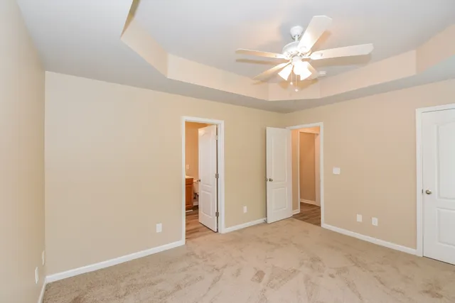 an empty room with a ceiling fan and a window