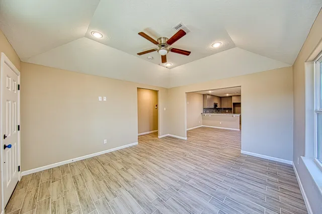 wooden floor in an empty room with a window