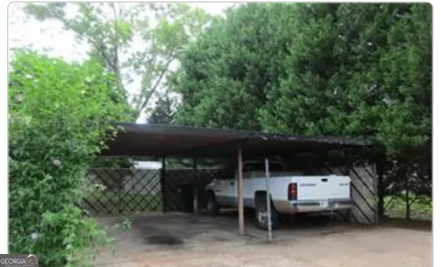 a view of patio with table and chairs and potted plants