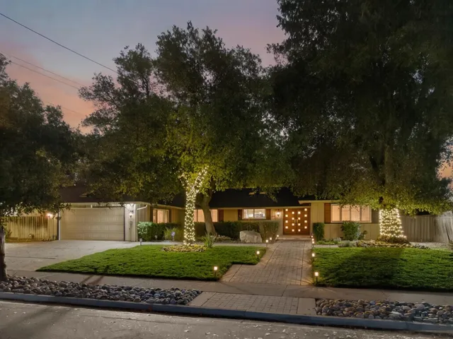a living room with furniture a fireplace and a wooden floor