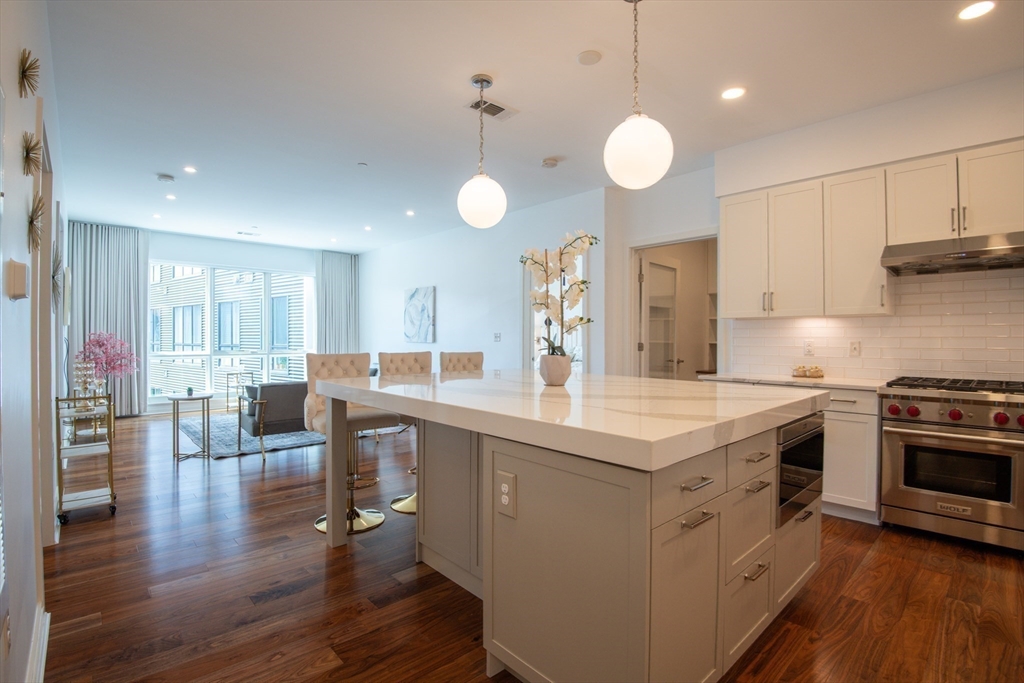 3531 Washington Street, Unit 316 Boston, MA 02130 - Photo 1 of 40 a kitchen with stainless steel appliances granite countertop a stove and a wooden floors
