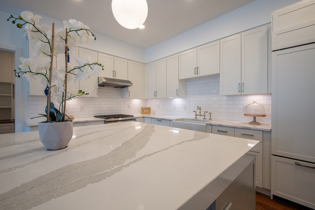 3531 Washington Street, Unit 316 Boston, MA 02130 - Photo 11 of 40 a kitchen with a stove and white cabinets