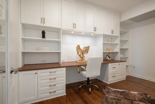 a kitchen with cabinets appliances and a wooden floor