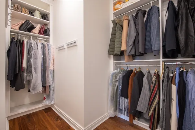 a view of walk in closet with clothes and shoes