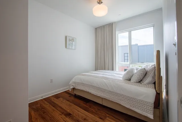 a bedroom with a bed and window