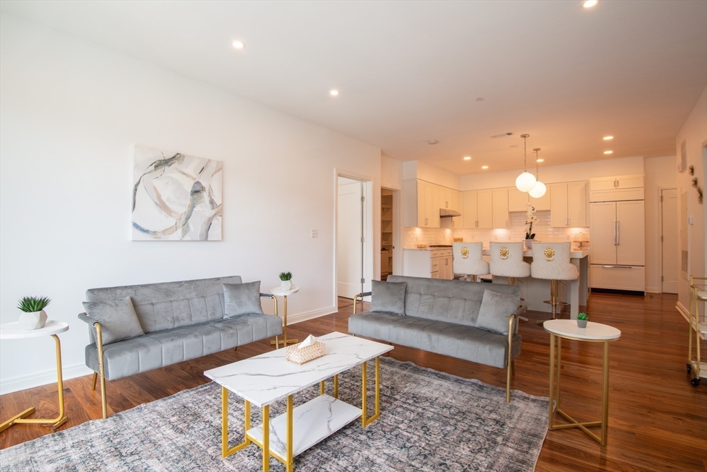 3531 Washington Street, Unit 316 Boston, MA 02130 - Photo 6 of 40 a living room with furniture and a dining table with kitchen view