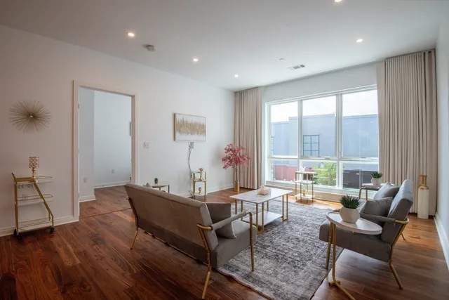 a living room with furniture and a large window