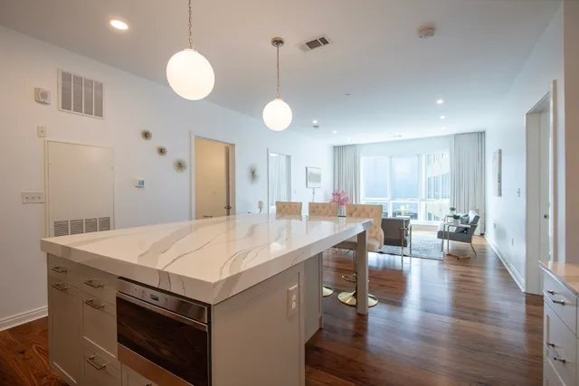 a large kitchen with a table and chairs