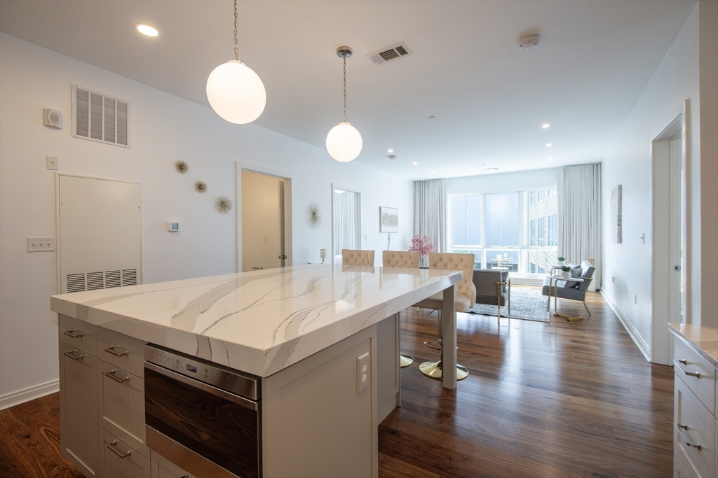 3531 Washington Street, Unit 316 Boston, MA 02130 - Photo 10 of 40 a large kitchen with a table and chairs