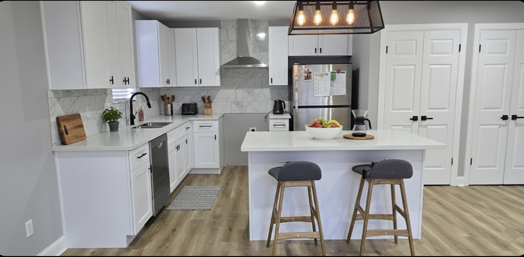 6502 Trail Valley Way Houston, TX 77086 - Photo 12 of 24 a kitchen with stainless steel appliances granite countertop a sink dishwasher and cabinets with wooden floor