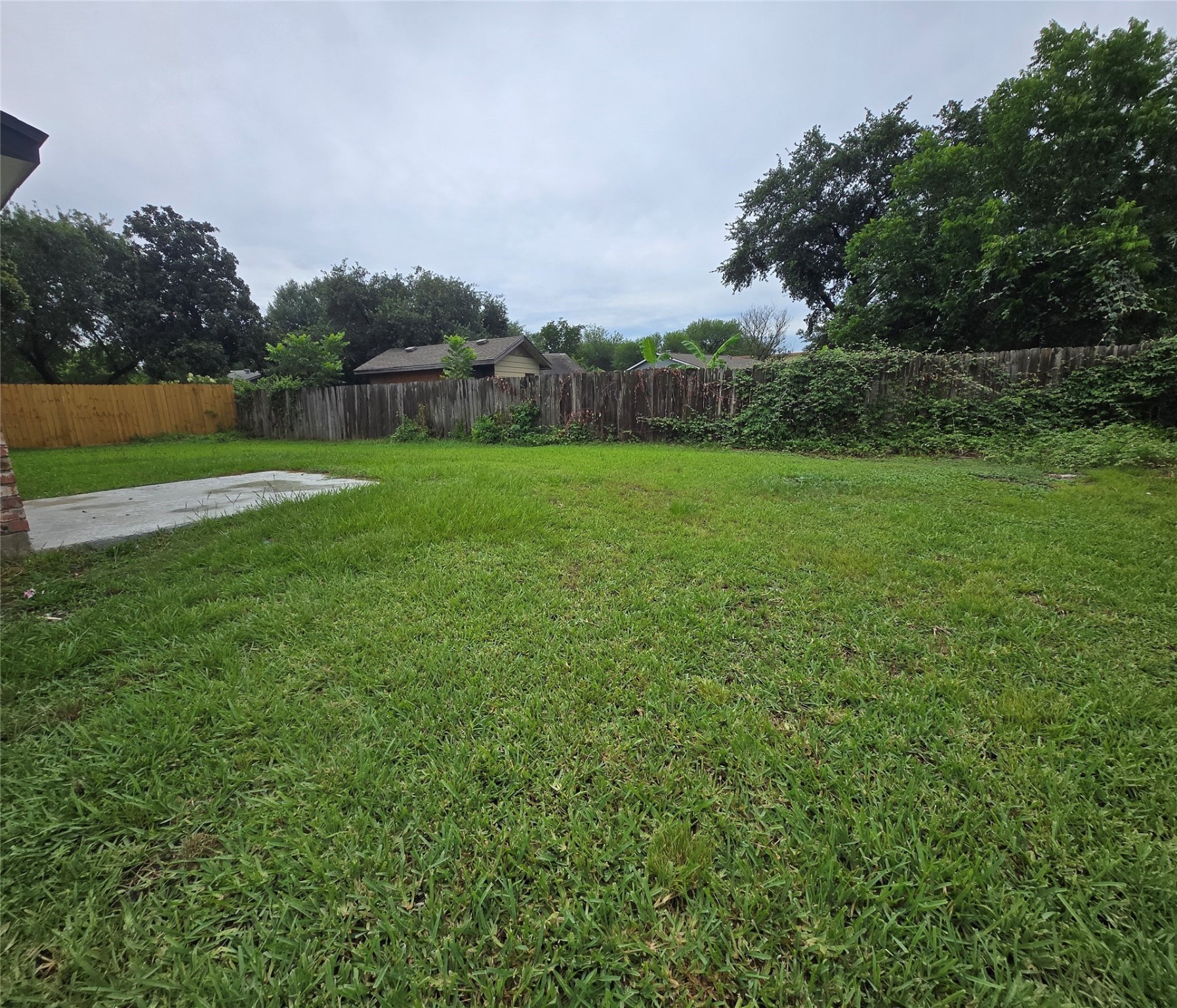 6502 Trail Valley Way Houston, TX 77086 - Photo 22 of 24 a view of a green field with wooden fence
