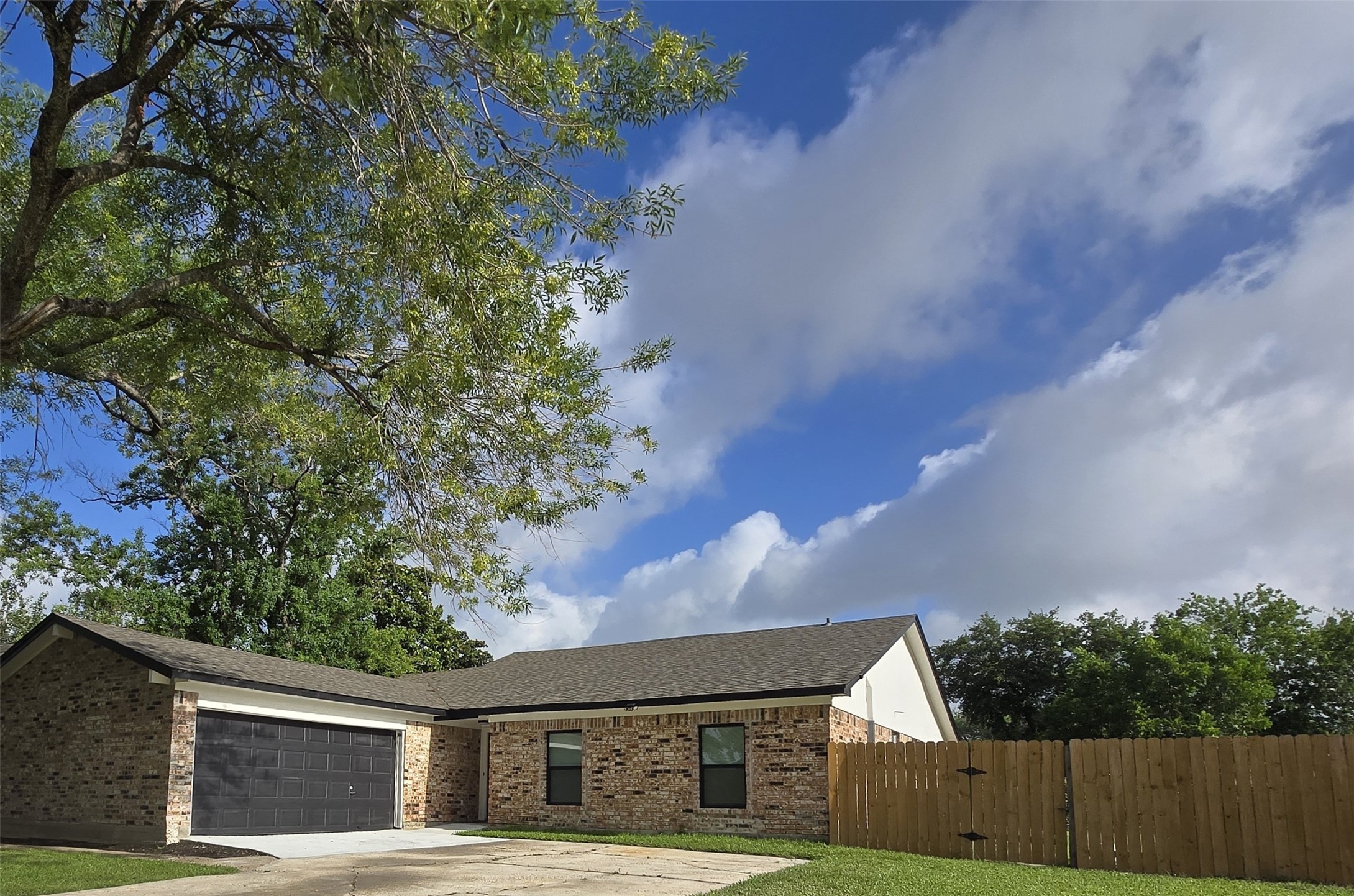6502 Trail Valley Way Houston, TX 77086 - Photo 4 of 24 a front view of a house with a garden