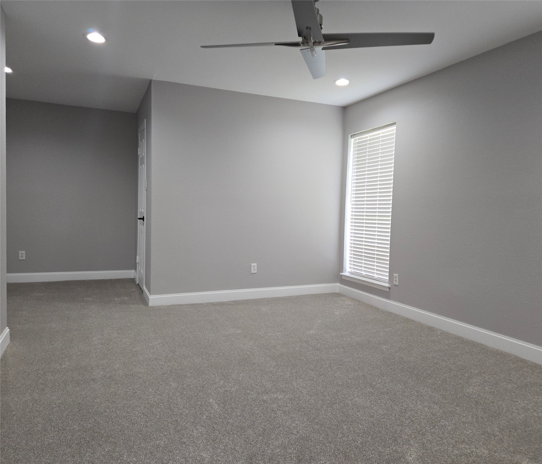 6502 Trail Valley Way Houston, TX 77086 - Photo 10 of 24 an empty room with windows and fan