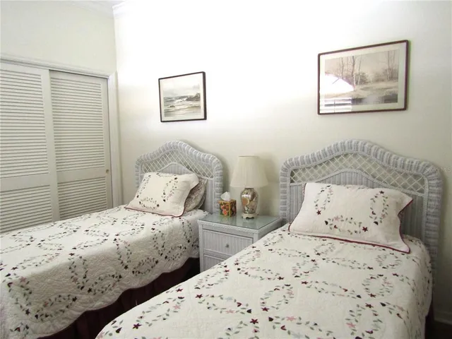 a bedroom with two bed and painting on the wall