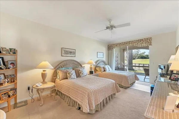 a spacious bedroom with two beds and glass table