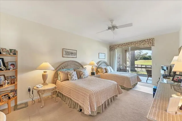 a spacious bedroom with two beds and glass table
