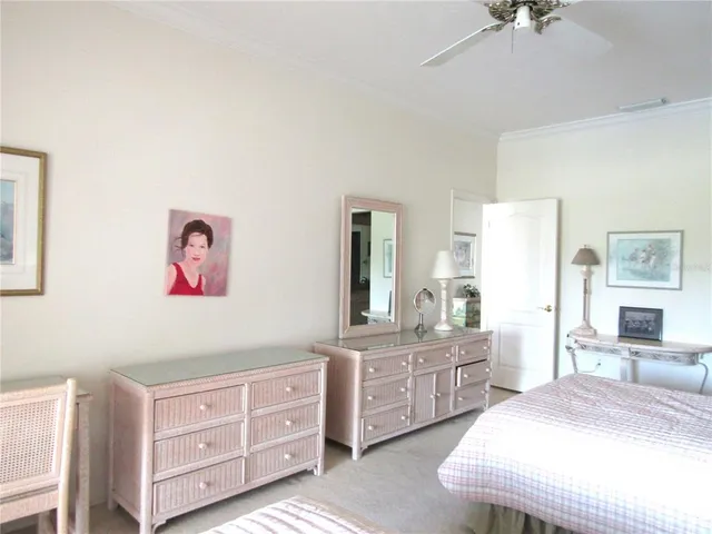 a spacious bedroom with a bed and a dresser