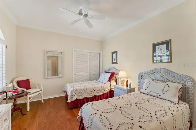 a bedroom with two beds and a chandelier
