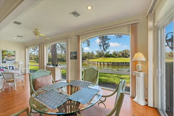 a dining room with furniture a rug and wooden floor