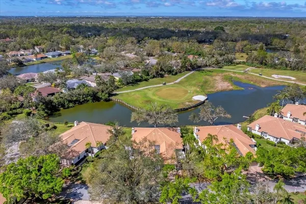 an aerial view of residential houses with outdoor space