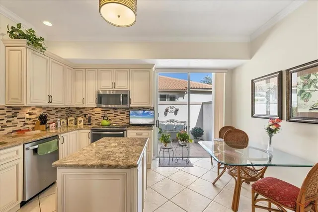 a kitchen with a stove cabinets and chairs in it