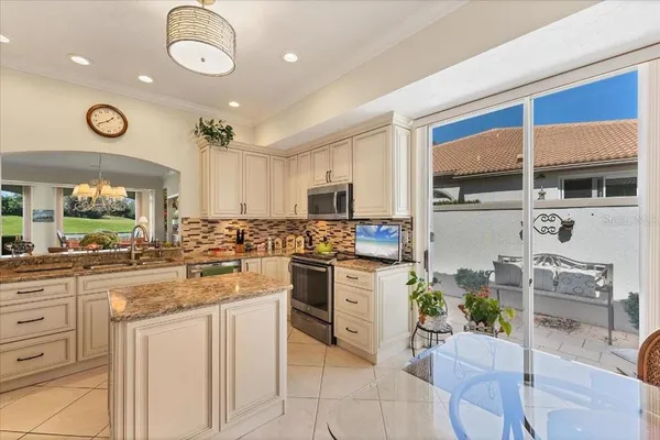 a kitchen with cabinets and chairs