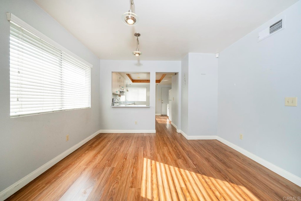 249 Fredricks Avenue Oceanside, CA 92058 - Photo 11 of 31 a view of empty room with wooden floor and fan