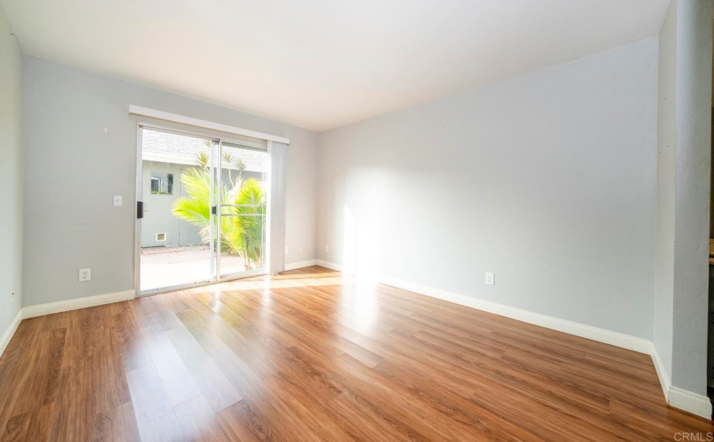 249 Fredricks Avenue Oceanside, CA 92058 - Photo 13 of 31 a view of an empty room with wooden floor and a window