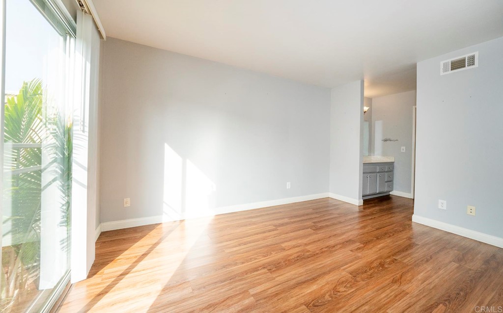 249 Fredricks Avenue Oceanside, CA 92058 - Photo 14 of 31 a view of an empty room with wooden floor and a window