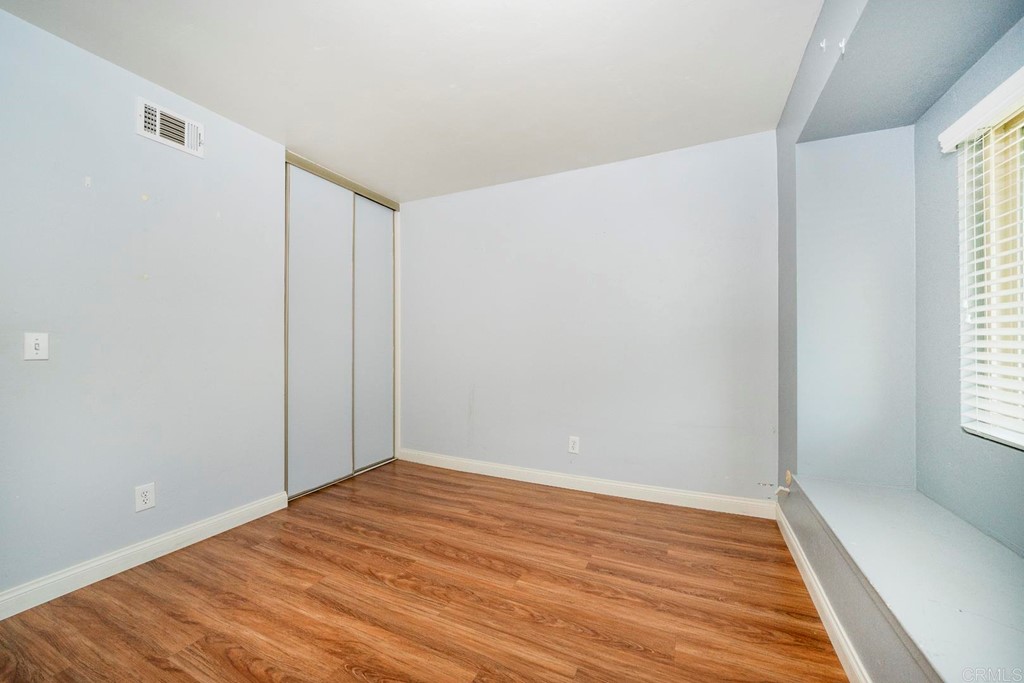 249 Fredricks Avenue Oceanside, CA 92058 - Photo 18 of 31 an empty room with wooden floor and windows