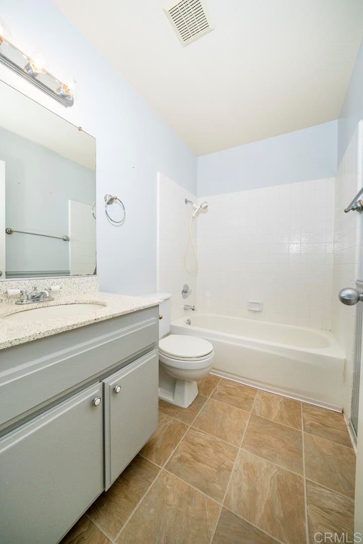 249 Fredricks Avenue Oceanside, CA 92058 - Photo 19 of 31 a bathroom with a granite countertop sink a toilet and bathtub