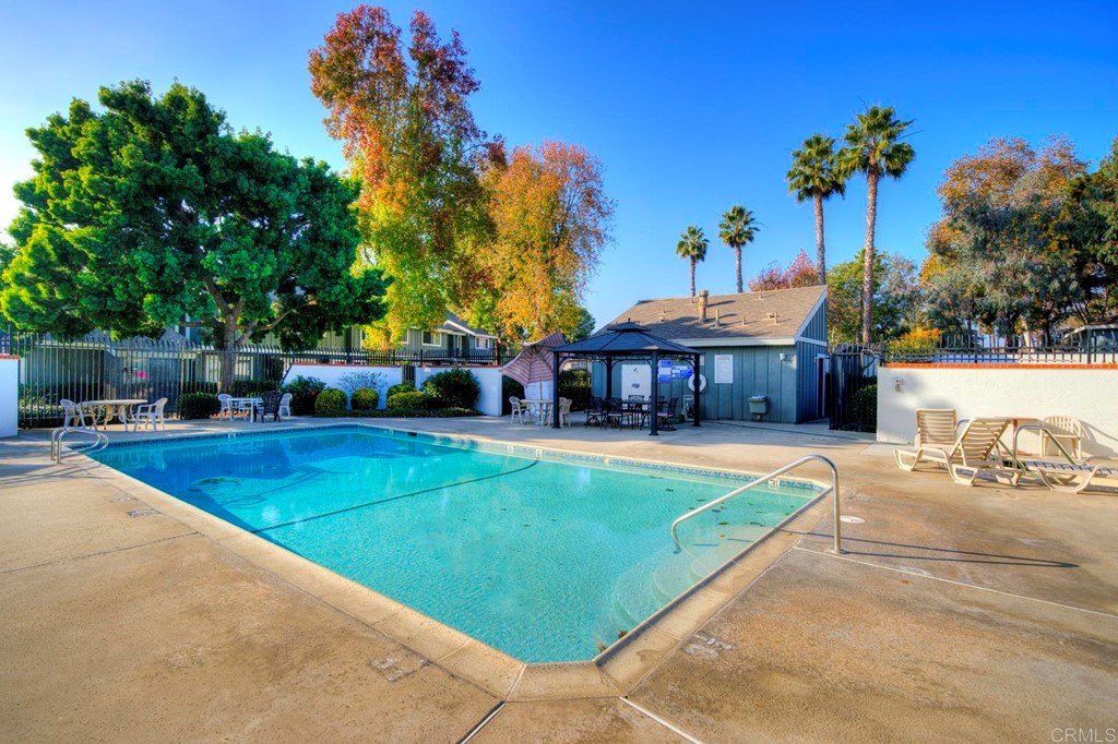 249 Fredricks Avenue Oceanside, CA 92058 - Photo 28 of 31 a view of a swimming pool with a table and chairs