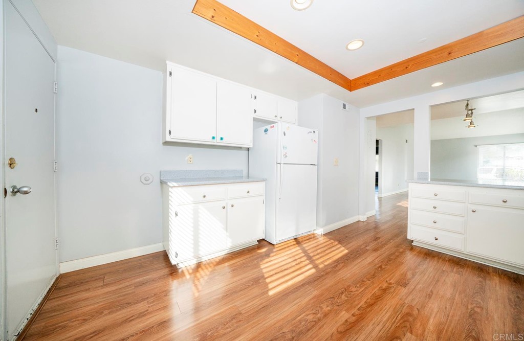 249 Fredricks Avenue Oceanside, CA 92058 - Photo 10 of 31 a kitchen with granite countertop a refrigerator and a stove top oven