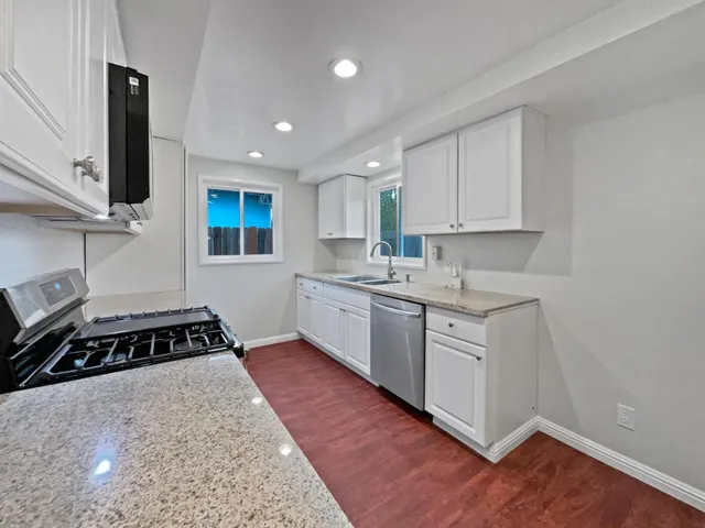 a kitchen with a sink stove and cabinets