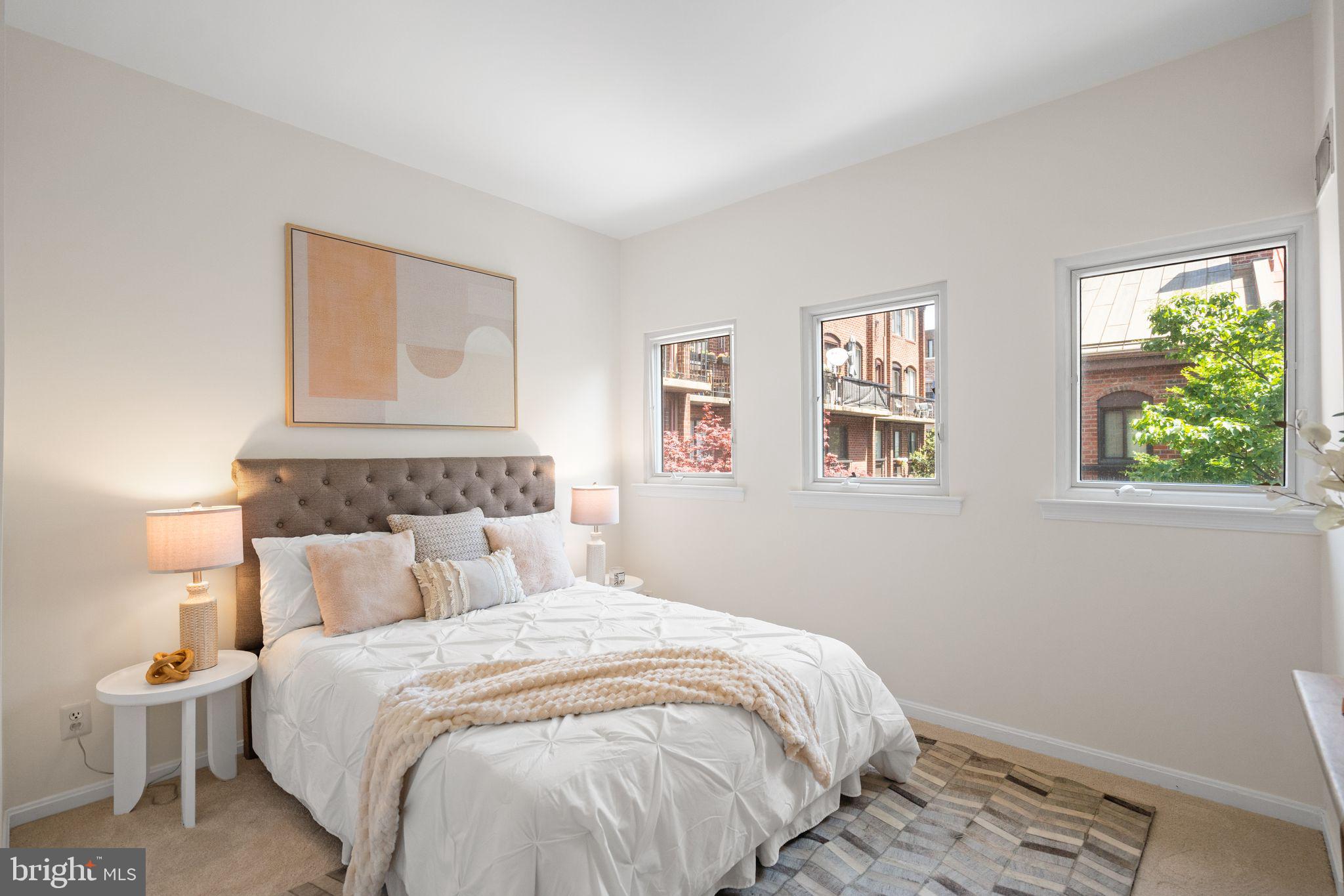 1008 Paper Mill Court, Unit 1008 Washington, DC 20007 - Photo 11 of 31 a bedroom with a bed and a window